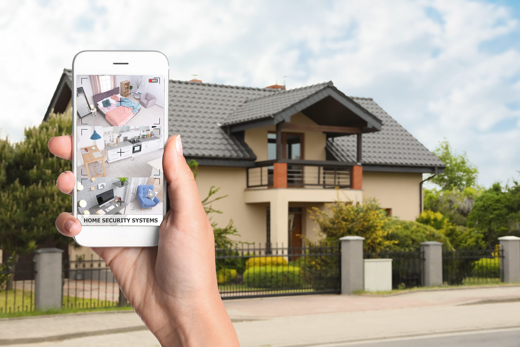 View of suburban street with beautiful house behind fence Smart Home security systems Pepper Pike