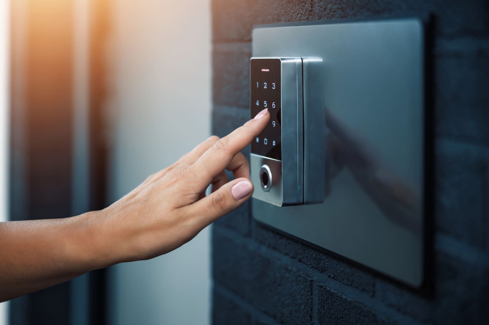Smart door lock installation Cleveland technician programming a modern digital keypad security system