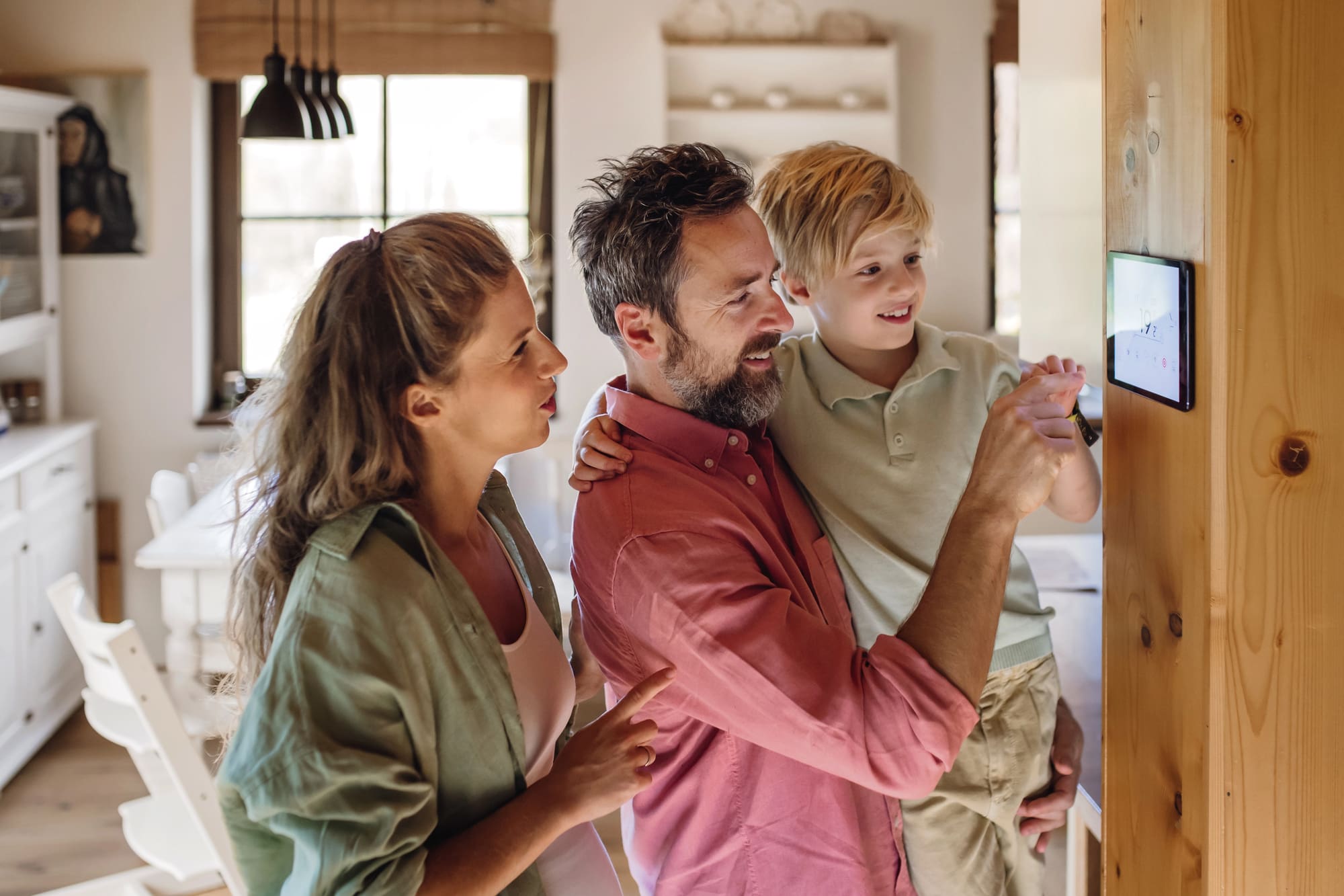 Smart thermostat installation Cleveland family enjoying their new home automation control panel.