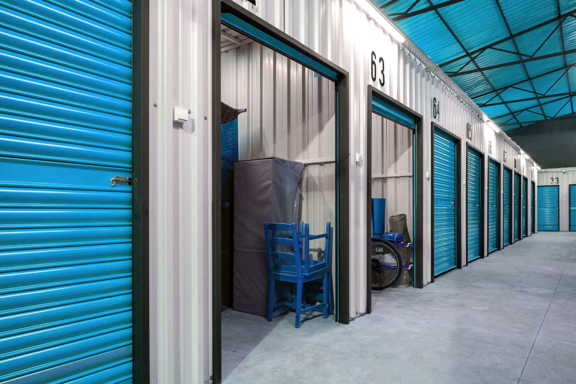 Commercial fire alarms protect self-storage facility with blue roll-up doors