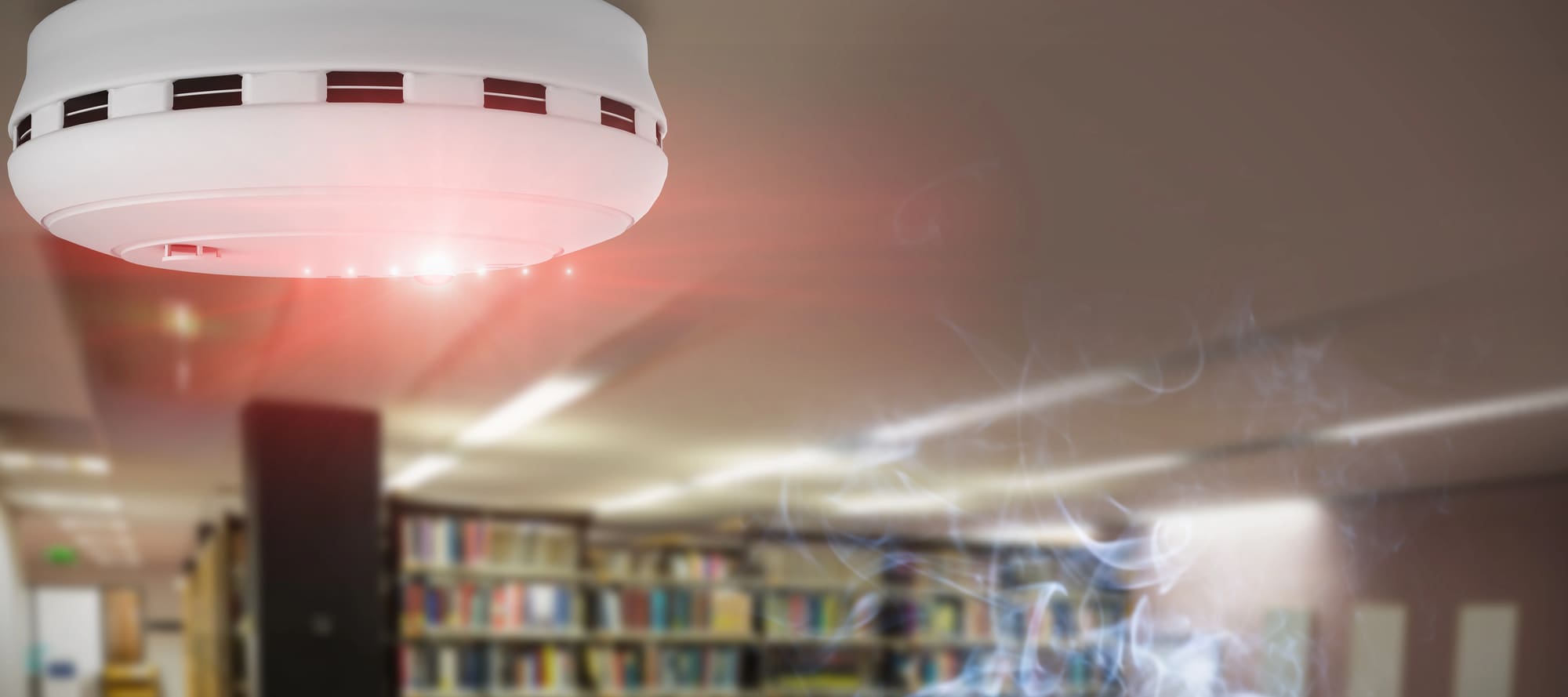 Commercial fire alarm repair services for smoke detector alerting occupants in library